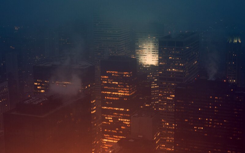 City skyline at night in fog