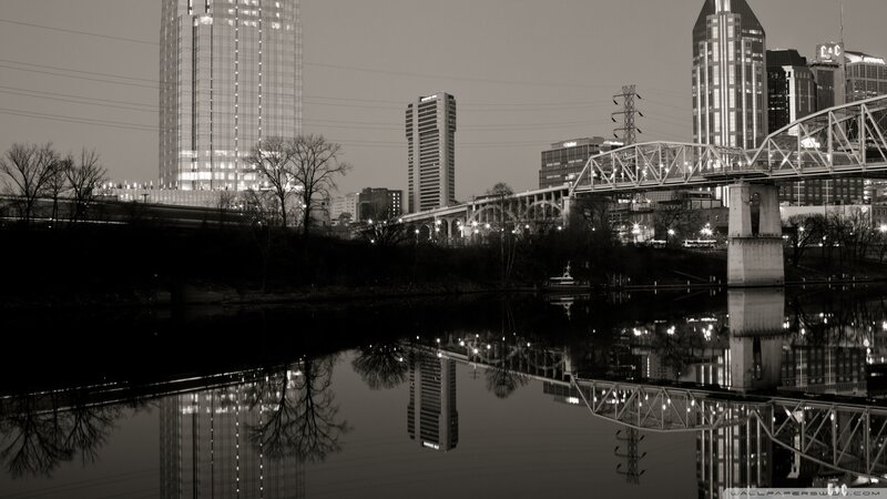 city skyline at night with bridge