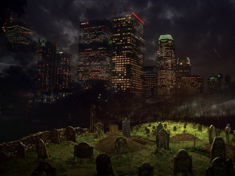 City skyline at night with cemetery