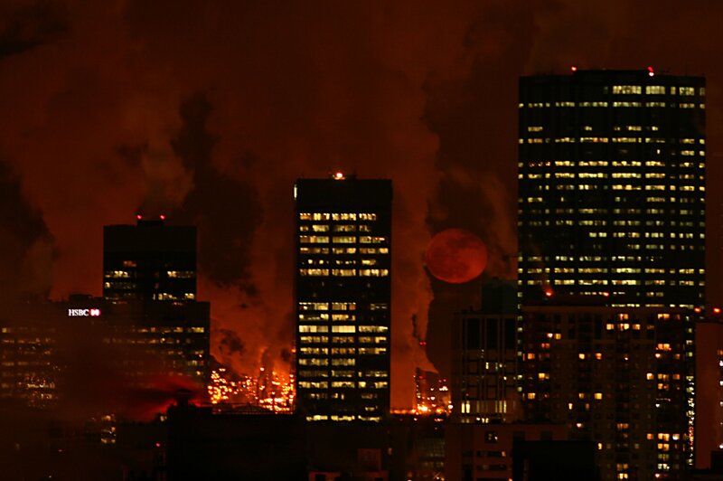 City skyline at night with fire