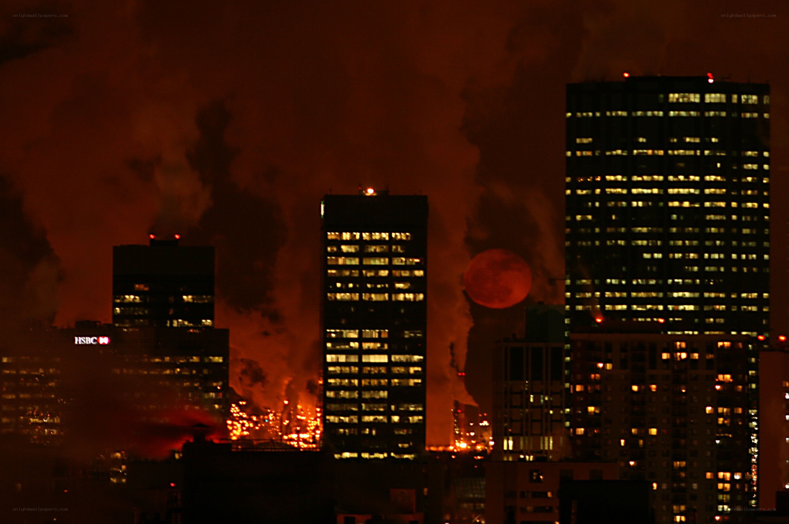 City skyline at night with fire