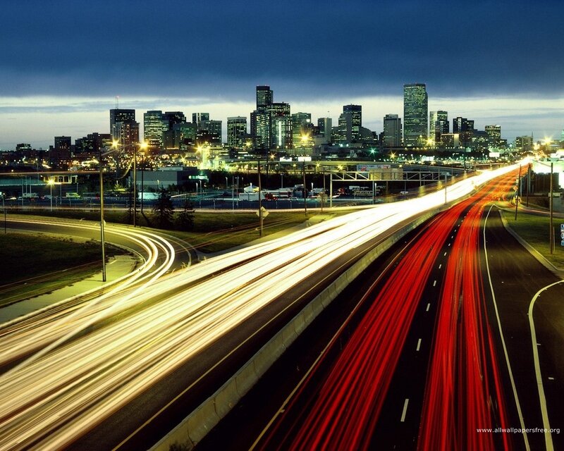 City skyline at night with light trails