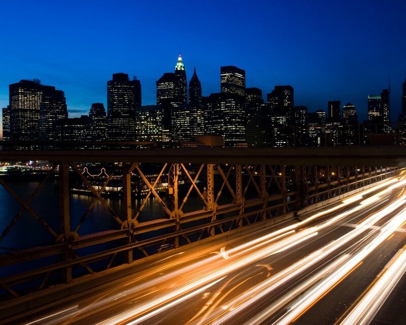 City skyline at night with light trails