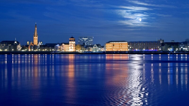 city skyline at night with moon
