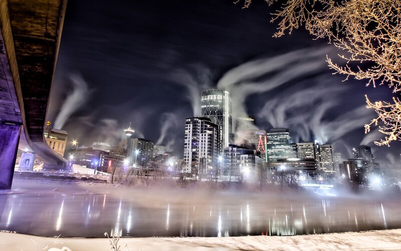 City skyline at night with steam