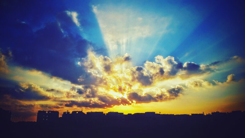 City Skyline at Sunset — Blue, Dramatic, Photograph, Clouds, Sunlight