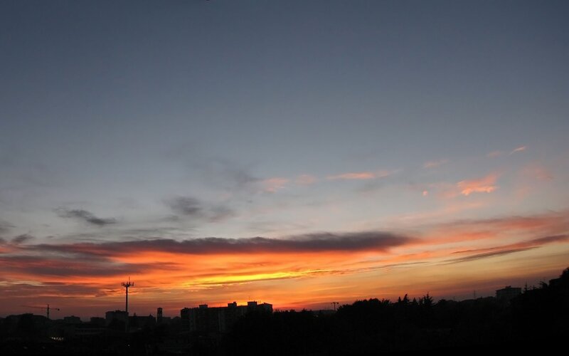 City Skyline at Sunset — Orange, Dramatic, Photograph, Buildings, Crane, Trees, Blue, Black