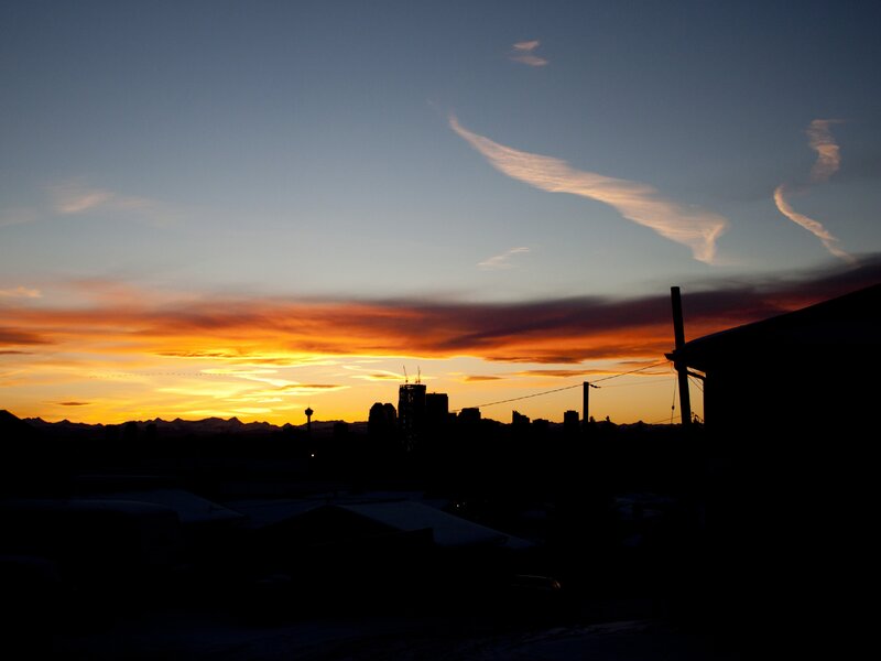City Skyline at Sunset — Orange, Dramatic, Photograph, Mountains, Clouds, Buildings, Power Lines