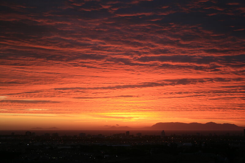 City Skyline at Sunset — Orange, Dramatic, Photograph, Mountains, Clouds, Buildings