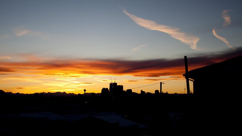 City Skyline at Sunset — Orange, Dramatic, Photograph, Mountains, Clouds