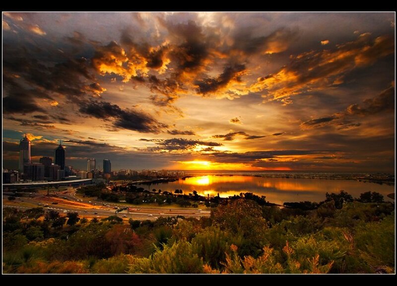 City Skyline at Sunset — Orange, Dramatic, Photograph, River, Clouds, Trees