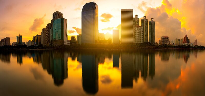 City Skyline at Sunset — Orange, Dramatic, Photograph, Skyscrapers, River, Clouds