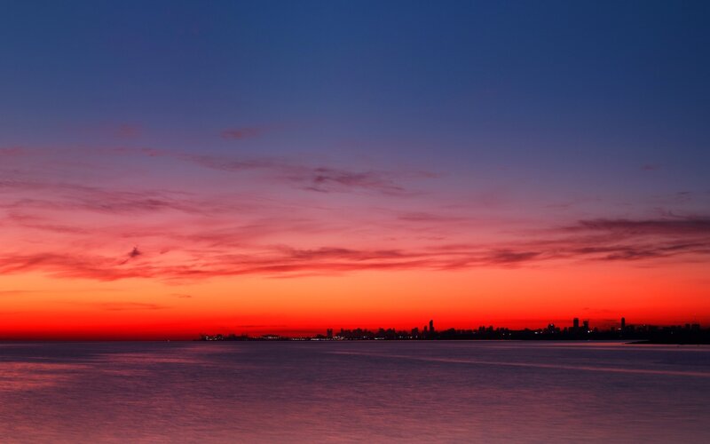 City Skyline at Sunset — Red, Dramatic, Photograph, Sky, Water, Clouds