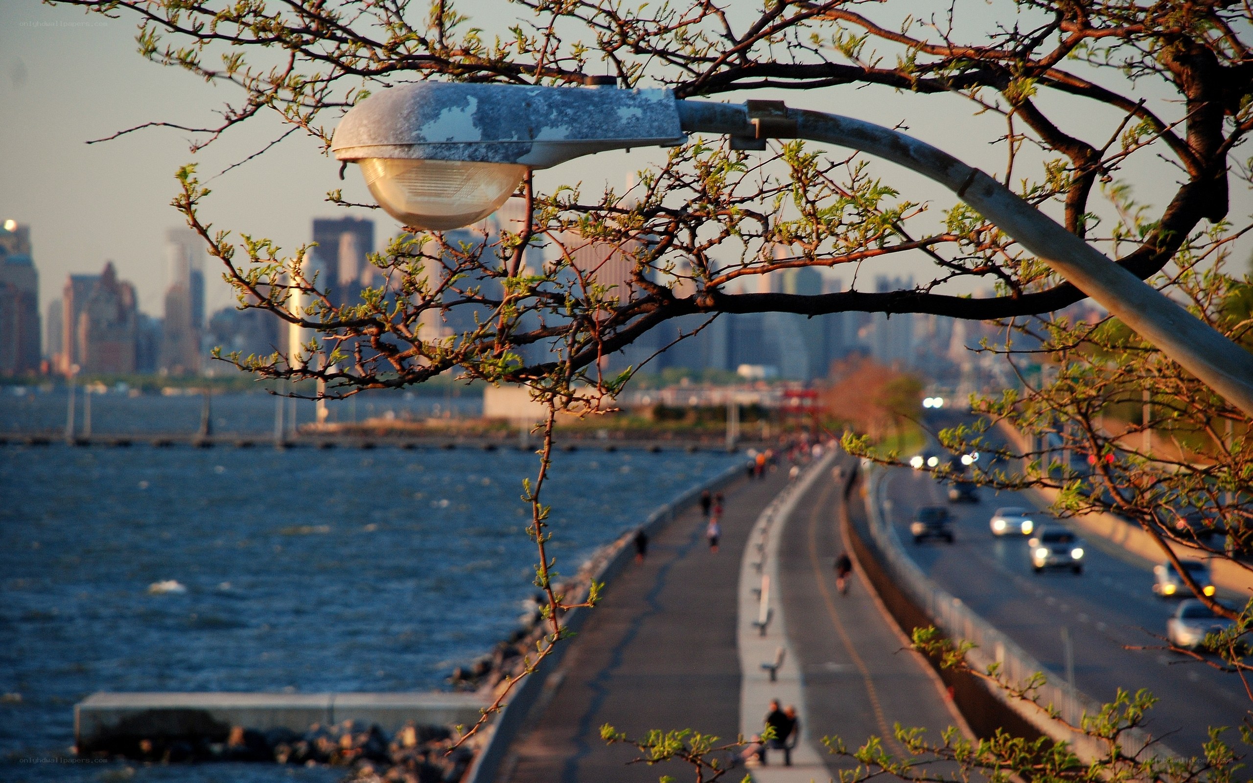 City skyline at sunset with waterfront path