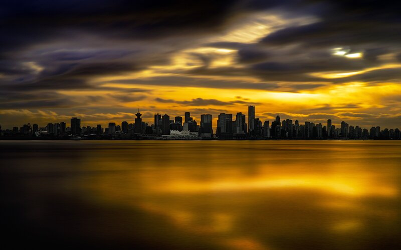 City Skyline at Sunset — Yellow, Dramatic, Photograph, Sky, Water
