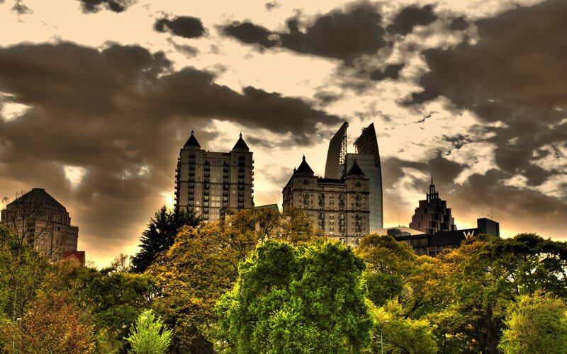 City Skyline Behind Trees — Green, Dramatic, Sunset