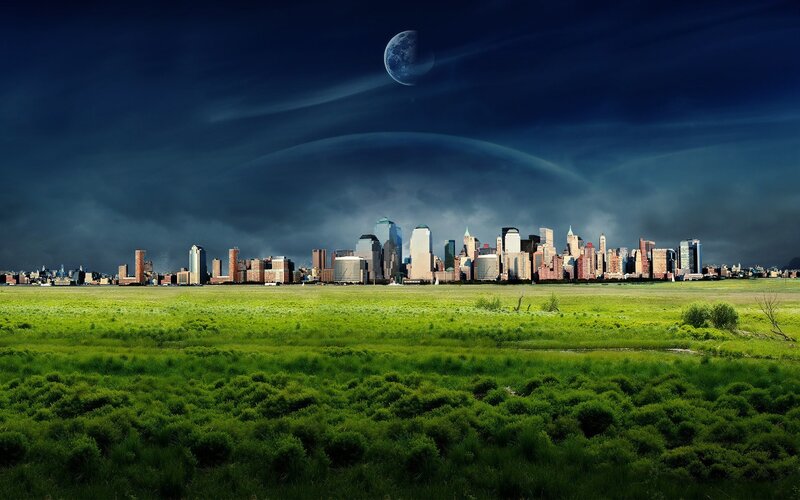 City skyline over green field