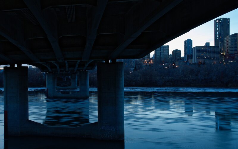 City skyline under a bridge