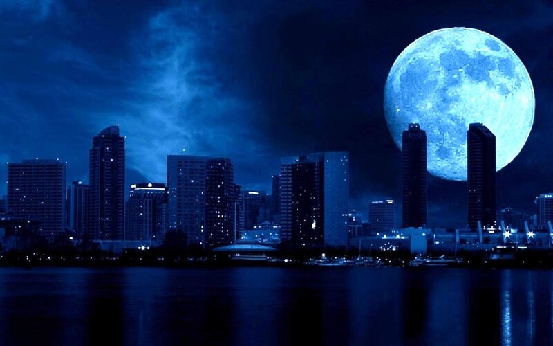 City skyline under blue moon