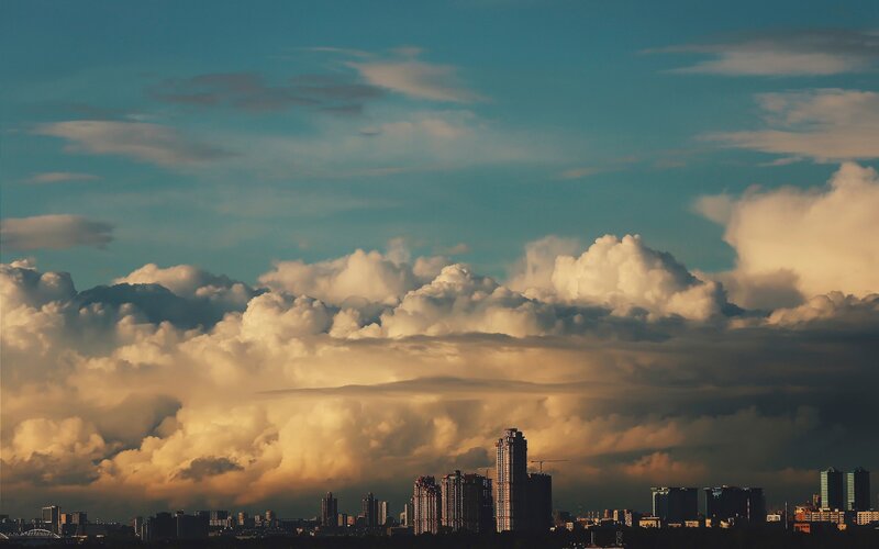 City Skyline under Storm Clouds — Blue, Dramatic