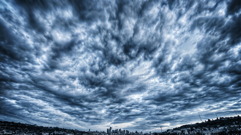 City Skyline under Storm Clouds — Blue