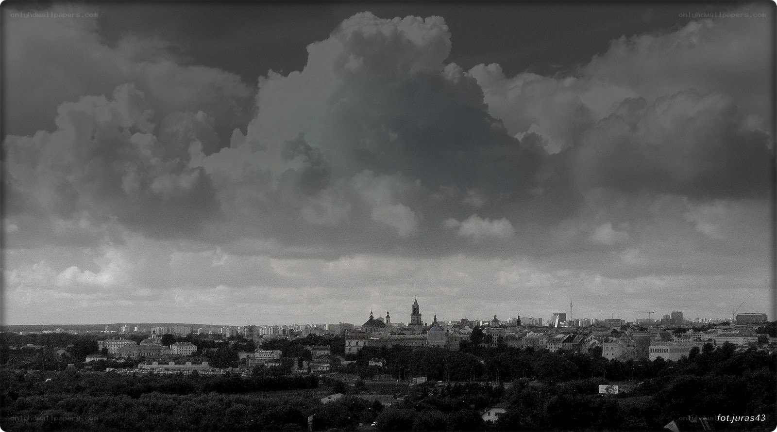 City skyline under stormy clouds