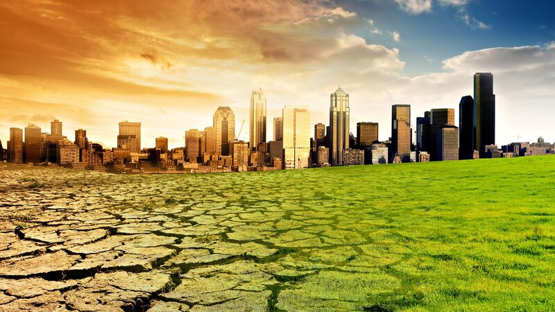 City skyline with cracked earth and grass