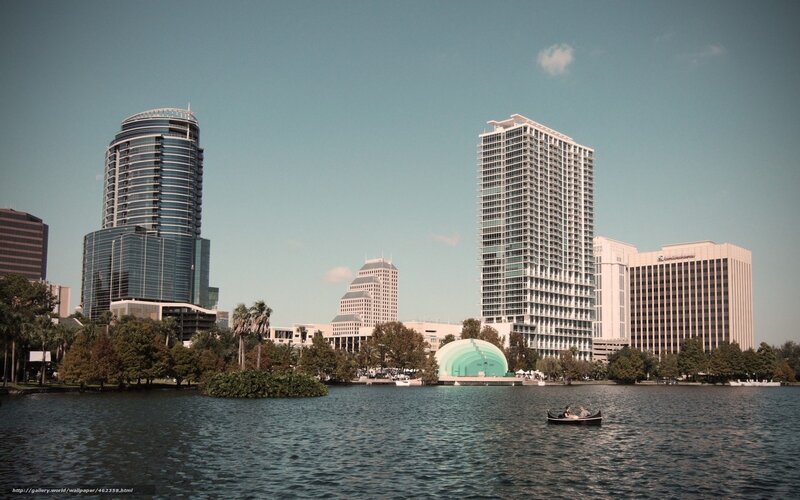 city skyline with lake and boats
