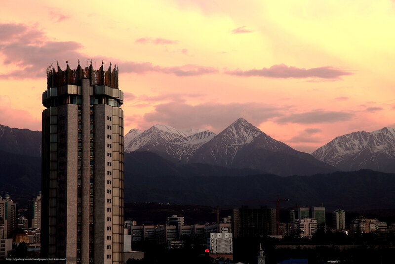 City skyline with mountains at sunset