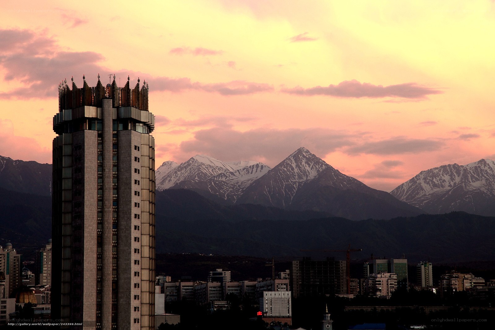 City skyline with mountains at sunset