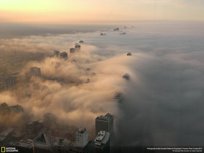 City skyscrapers above fog