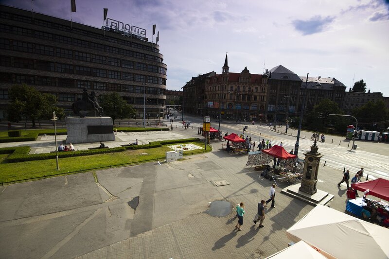 City square with monument and market