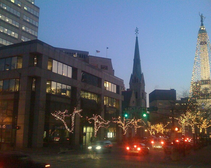 City street at dusk with holiday lights