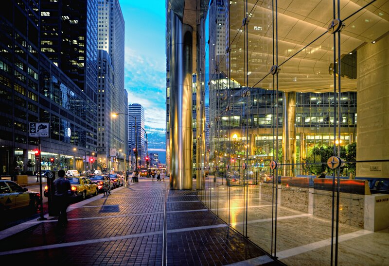 City street at dusk with skyscrapers