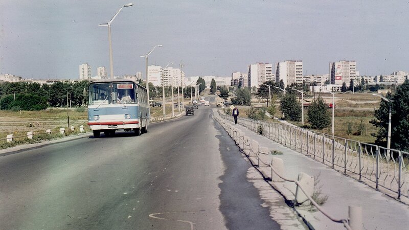 City street with bus and apartment buildings