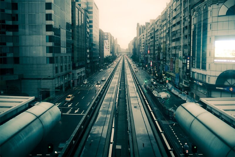 City street with elevated train tracks