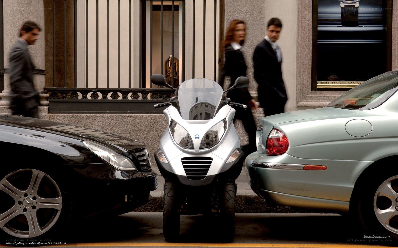 City street with scooter and cars