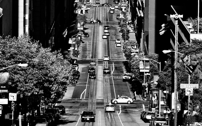 City street with traffic and trolley tracks