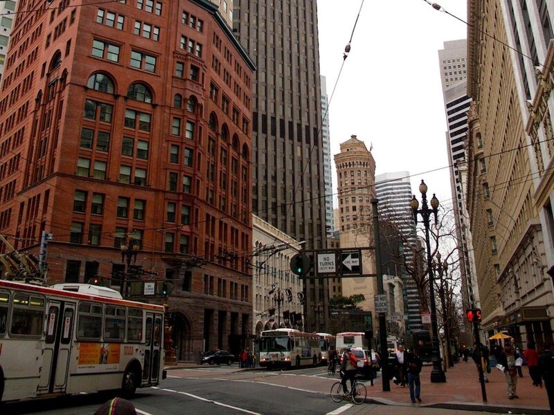 City street with trolleybuses and historic buildings