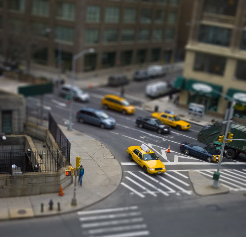 city street with yellow taxi