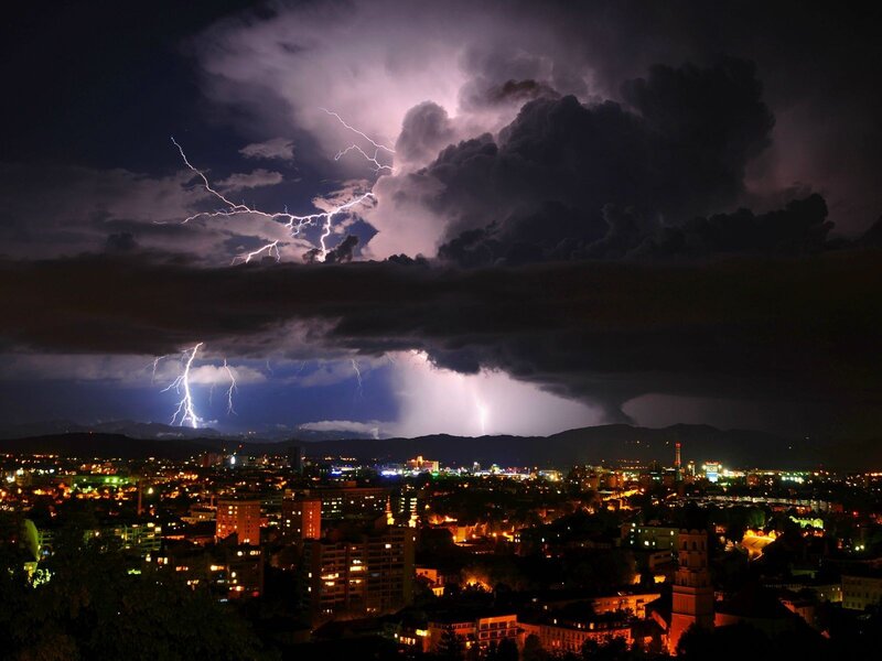 City under stormy lightning sky