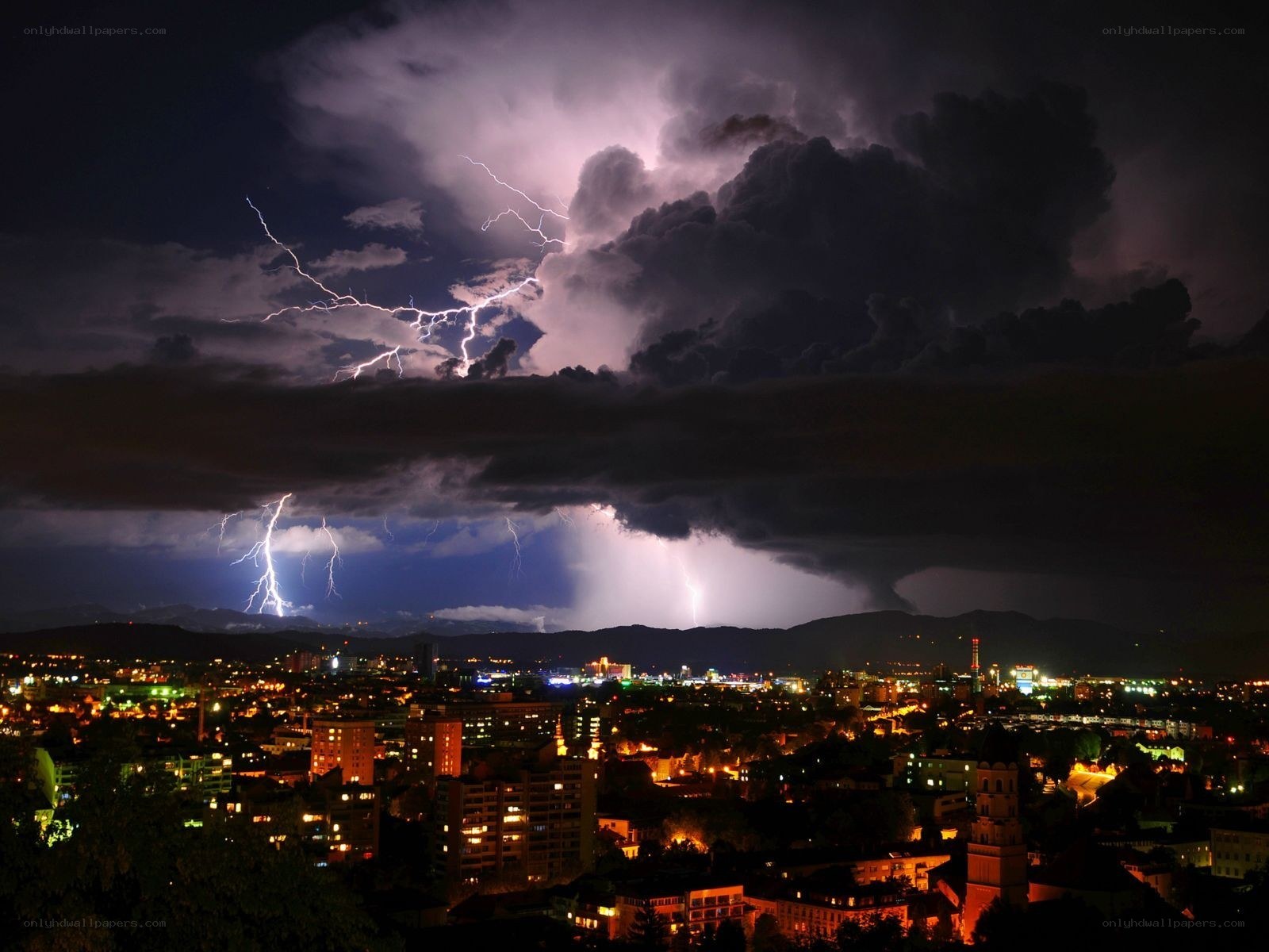 City under stormy lightning sky