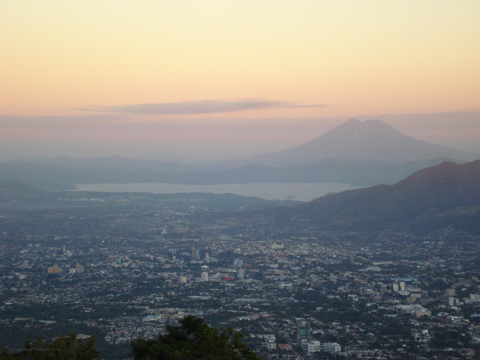City view at dusk with volcano