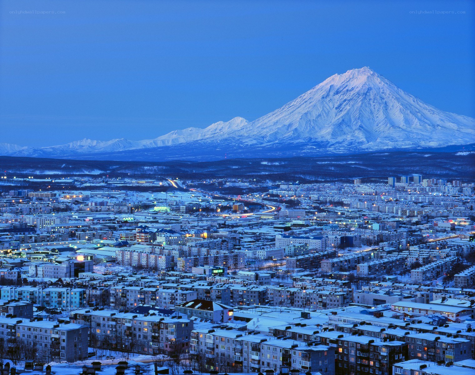 City with snow-capped mountain