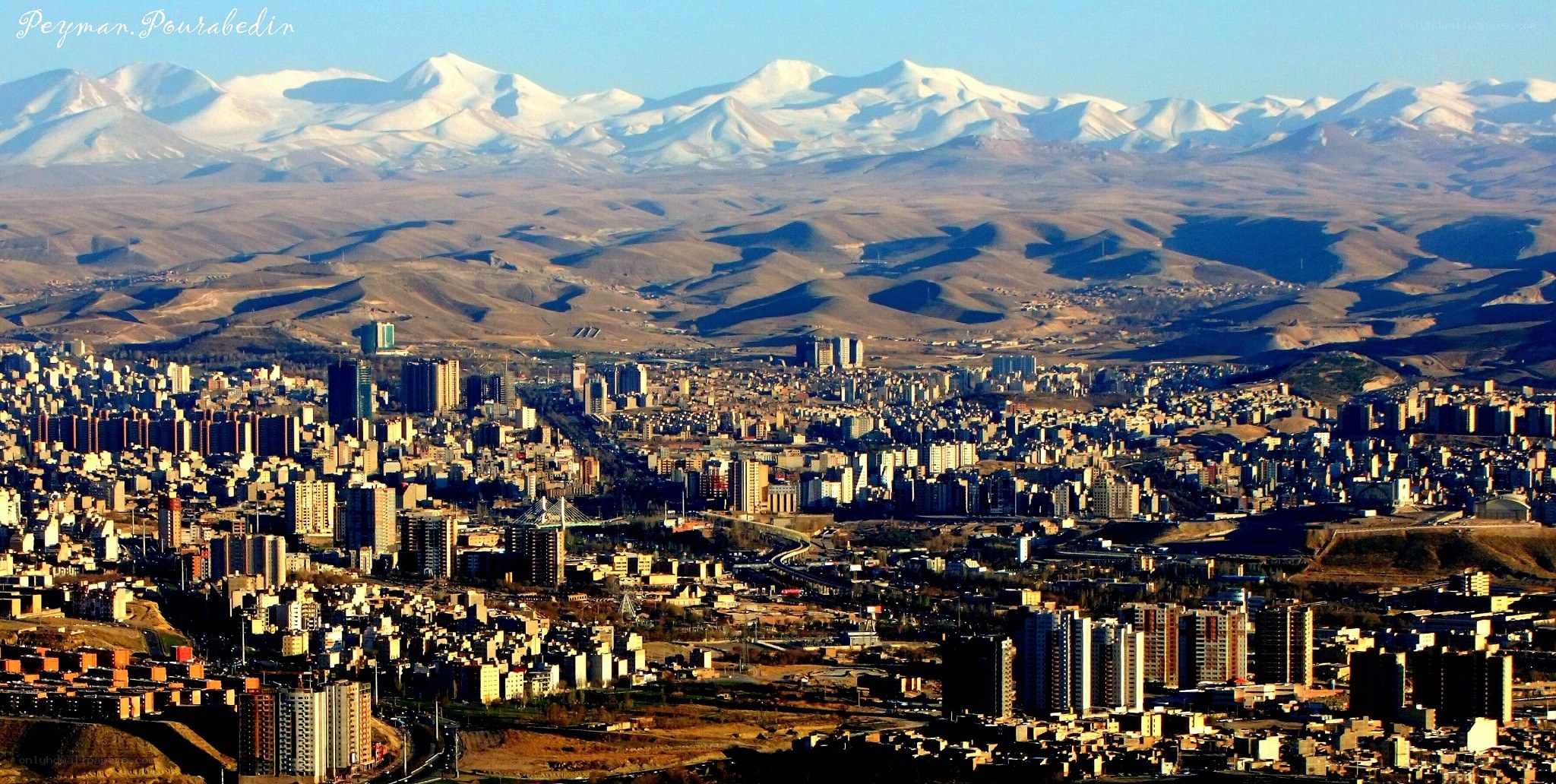 city with snow-capped mountains