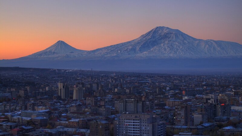 City with Snow-capped Mountains — Orange
