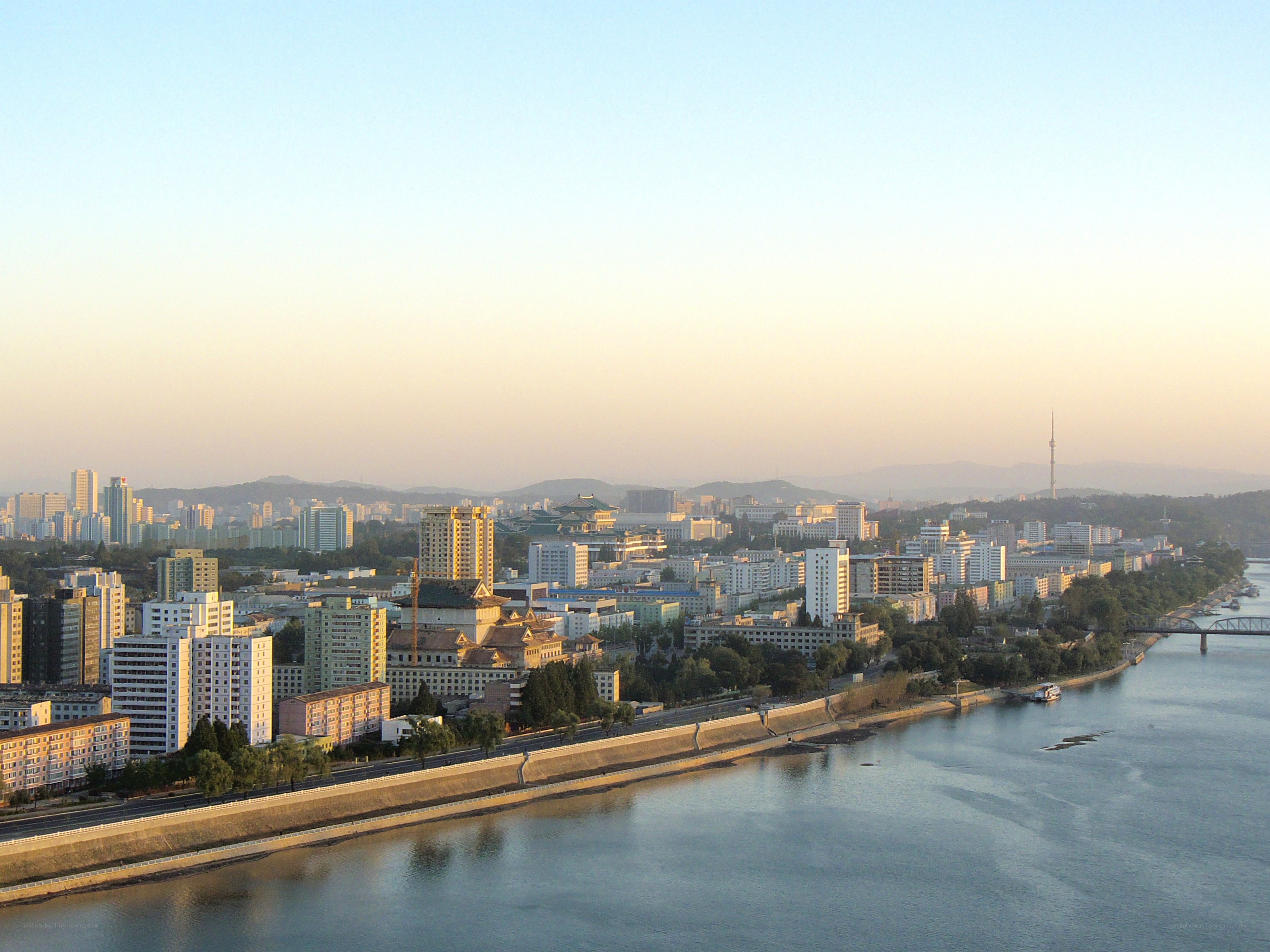cityscape along a river at dawn