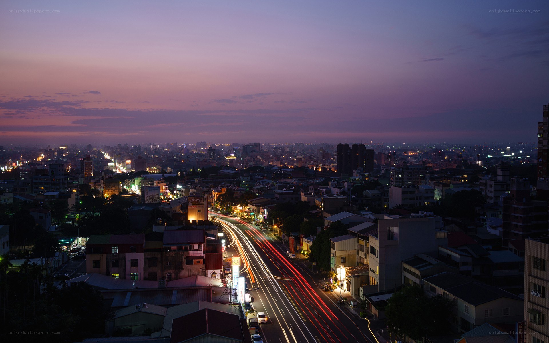 Cityscape at dusk with light trails