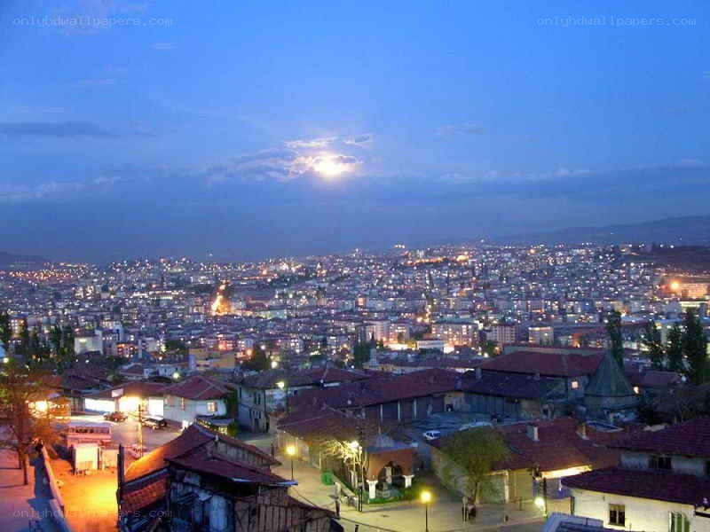 cityscape at dusk with moon