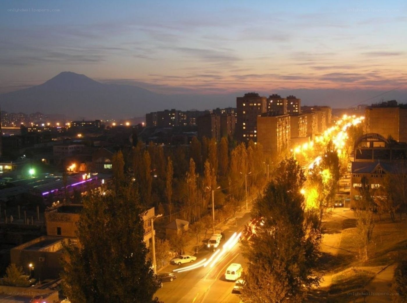 Cityscape at dusk with mountain